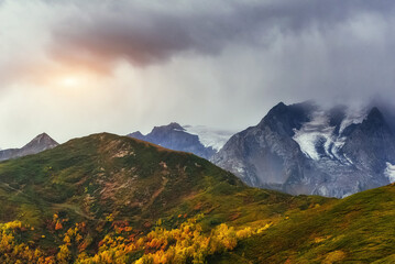 Sunset over snow-capped mountain peaks.