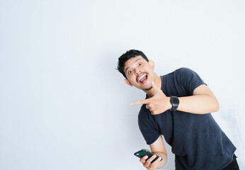Asian man holding mobile phone and feeling shocked portrait white isolated