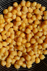 Top view of cooked chickpeas in a strainer