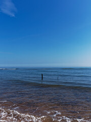 2 Old Wooden Net posts exposed at low tide on Elliot Beach near to Arbroath with small waves...