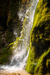 Waterfall „Dreimühlen-Wasserfall“ in Nohn (Eifel, Germany) backlit by bright sunlight in...