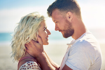Obraz premium Smile, couple and holiday on beach with love for seaside romance, serene seascape and ocean view with affection. Man, woman and together for bonding by coast on weekend date, embrace and hug