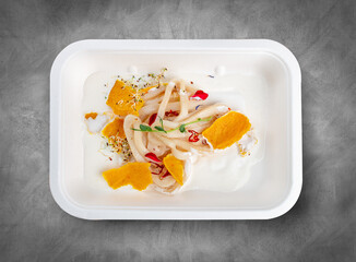 Calamari in yogurt according to Dukan. Healthy diet. Takeaway food. Eco packaging. Top view, on a...