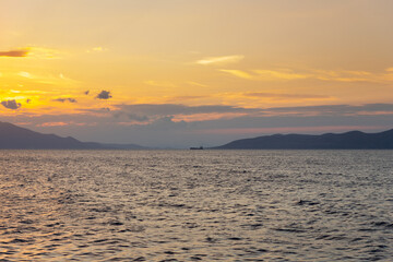 Mediterranean Sea in Evia island with view of Pelion mountain at sunset in background
