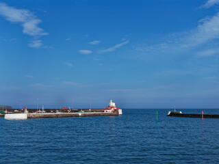 The Signal Lighthouse and West Breakwater Marker at Arbroath Harbour on the East Coast of Scotland at High Tide in May.