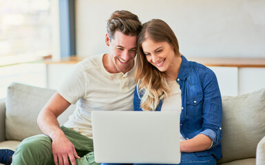 Couple, sofa and online on laptop with happiness for approved application on rental confirmation...