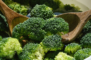 Raw sliced Broccoli with two wooden spoons. Organic broccoli, ingredient vegetable healthy nature...