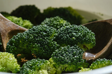 Raw sliced Broccoli with two wooden spoons.  Organic broccoli, ingredient vegetable healthy nature...