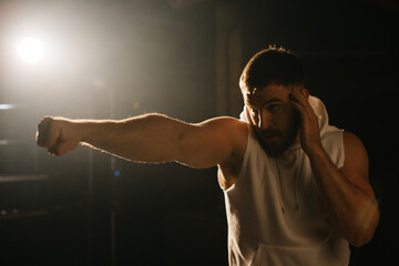 A man trains in a boxing club, a fight with a shadow.