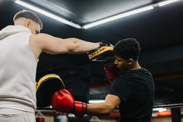 Coach and Young Boxer Practice Techniques in the Ring