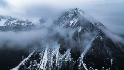 Mountain American nature with clouds. Clouds over forest of Mount Rainier park.