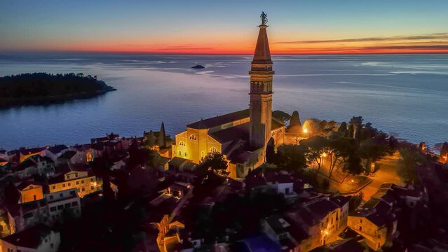 Evening HDR shot of Church of Saint Euphemia in old town of Rovinj, Croatia. Sea and sunset sky at background, aerial shot, 4K