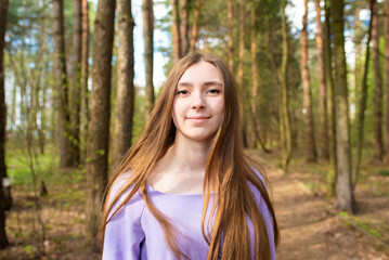  Portrait of a beautiful teenage girl, young woman with long hair in the park
