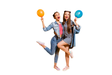 Full legs length body size portrait of two funky funny brunette hair lady stand isolated on yellow vivid background with fly ball in hands make beaming wide toothy smile
