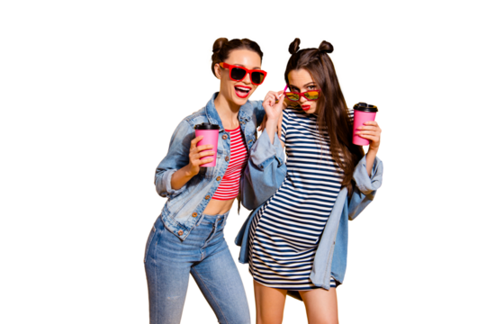 Two beautiful attractive cute sweet gorgeous brunette hair lady look at camera pose isolated on yellow vivid background in glasses spectacles make beaming white smile hold cup in hands