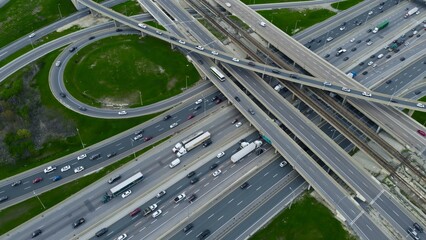 Vehicles coast along urban expressways, aerial captures reveal extent of daily commute. Aerial...