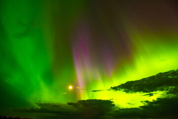 The Aurora Borealis or northern lights creates a incredible display of beautiful multi colored light in the sky above North Dakota.