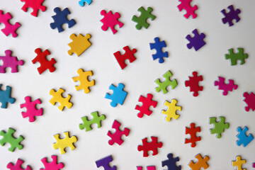 Colorful jigsaw puzzle pieces on white background. Flat lay.