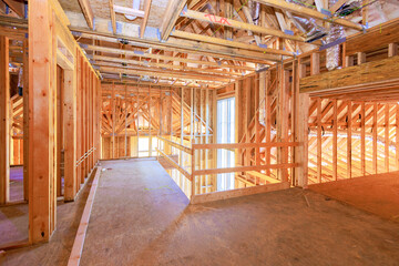 New residential under construction is framing an unfinished wood frame with wooden truss, post beam...