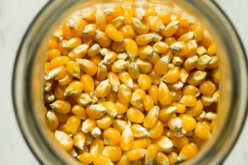 Macro photo of raw corn inside a glass jar.
