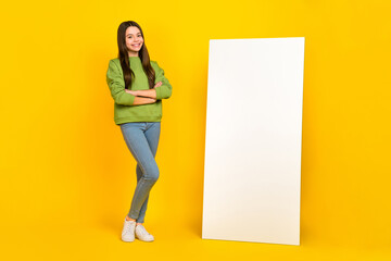 Full body photo of young girl promoter crossed hands modern technology menu website isolated over yellow color background