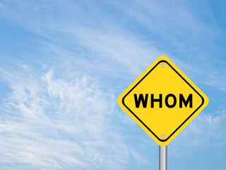 Naklejka premium Yellow transportation sign with word whom on blue color sky background