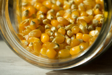 Macro photo of raw corn inside a glass jar.