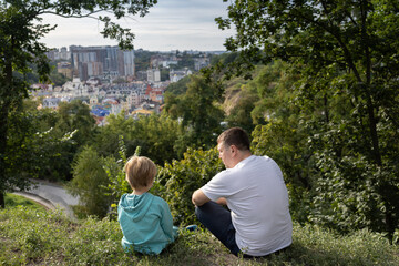 father and son are relaxing in the park. Digital detox. Recreation, local hikes, family outings, relaxation, environment. interesting weekend, friendly conversations