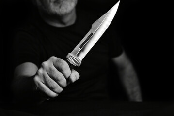 man wielding make expressively holding cutting metal blade black and white photo art expression
