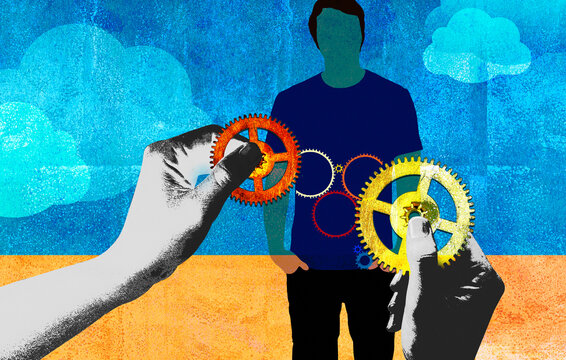 Hands holding cogs over man