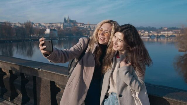 Female friends taking selfe in Prague. Travel, friendship, youth, millenial, blogger, fame social media concept. Filmed on REd 4k, 10 bit color