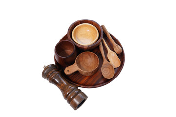 Kitchen utensils, spoons, forks, wooden cups on white background.