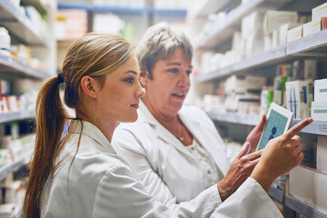 Pharmacist, women and together with tablet for inventory on shelf, stock and check with pointing in...