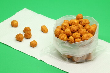 Malaysian delicious snack with a traditional legendary recipe featuring ground peanuts, spice powder, sesame seeds, and more. Homemade, fried, and served, found at your convenience store.