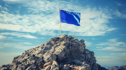 blue flag on mountain peak motivational success concept