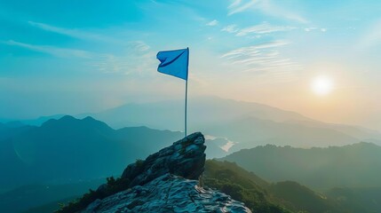 blue flag on mountain peak motivational success concept