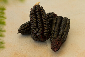 Group photo of purple corn on a table.