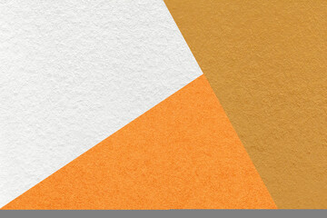 Texture of craft ocher, white and orange shade color paper background, macro. Vintage abstract yellow cardboard