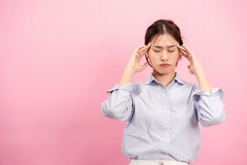 Young asian woman using fingers with both hands to touching and massaging forehead while suffering...