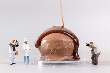 Professional confectioner making tasty chocolate dessert on gray background, World chocolate day...