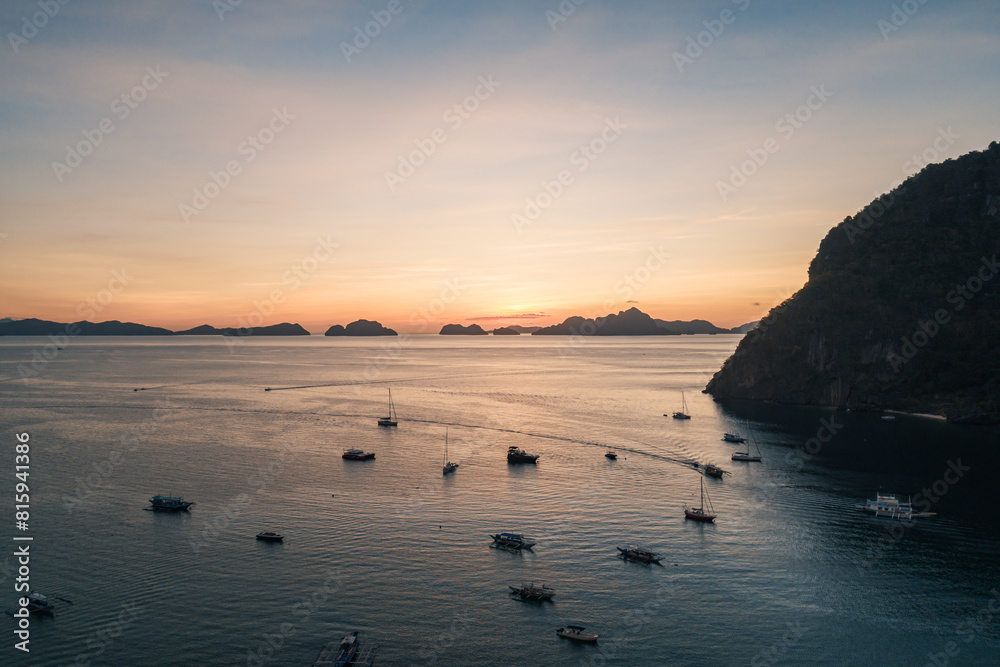 Wall mural Aerial view of boats and yachts in the tropical bay on the sunset. El Nido, Palawan, Philippines. Travel concept.