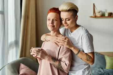 Two women with short hair embrace each other in a cozy living room, reflecting the beauty of love...