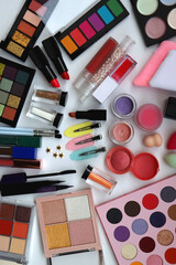 Various colorful beauty products on white background. Top view.