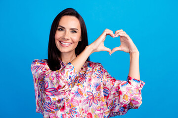 Photo of excited adorable lady dressed print blouse showing arms heart isolated blue color...