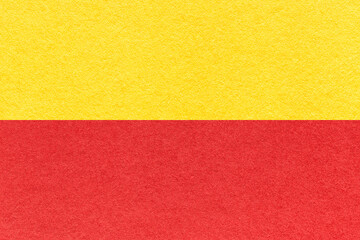 Texture of craft red and yellow paper background, half two colors, macro. Structure of vintage...