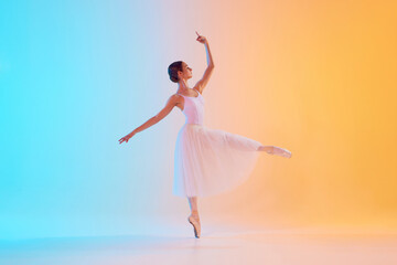 Fototapeta premium Graceful, tender ballerina performing pirouette in motion in neon light against blue-orange gradient background. Concept of art, movement, classical and modern fusion, beauty and fashion. Ad