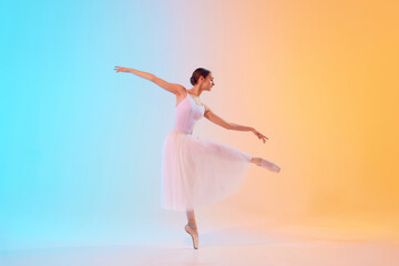Obraz premium Artistic, tender ballerina performing pirouette in motion in neon light against blue-orange gradient background. Concept of art, movement, classical and modern fusion, beauty and fashion. Ad