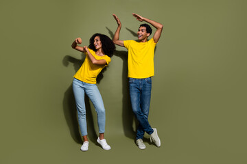 Full body portrait of two nice people chill dance wear t-shirt isolated on khaki color background