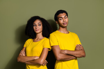 Fototapeta premium Portrait of two nice people folded hands look each other wear t-shirt isolated on khaki color background