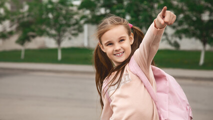 Happy pretty school girl holding backpack. schooler going to school, enjoying studying. School,...